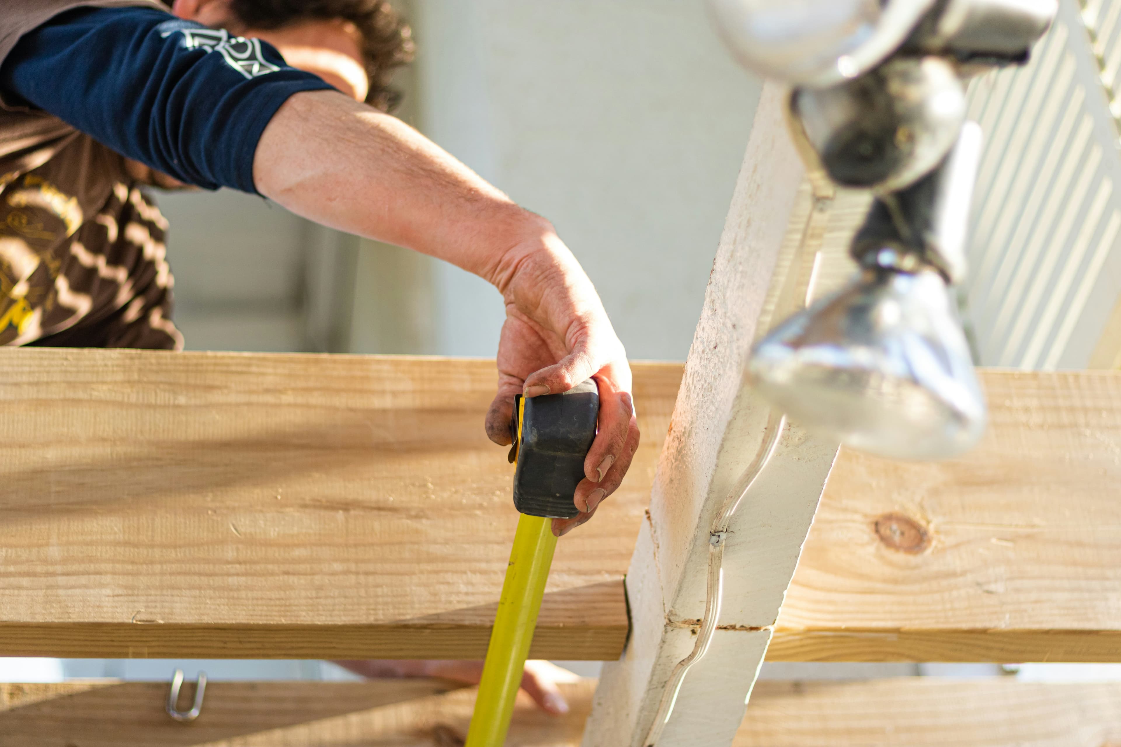 Builder measuring framing lumber